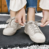 Lifestyle shot of Distressed Leather Sneakers paired with casual jeans