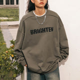 Female model wearing the Distressed Letter Printed Sweatshirt for a stylish look