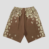 Loose-fit unisex shorts with quick-dry fabric and floral Sanskrit design