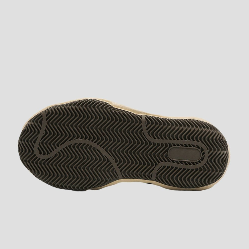 Detailed tread pattern on the rubber outsole, providing superior grip and durability on various surfaces