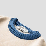  Detailed image of the sweater's collar showing its cozy, high-neck design.